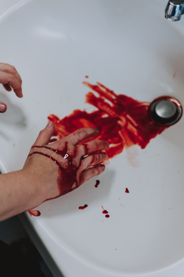 hands bleeding over a sink